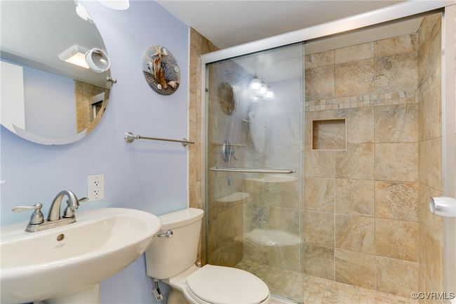 Full Primary bathroom featuring a shower stall, toilet, and a sink | Image 14