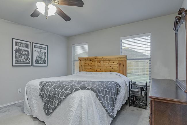 Bedroom with baseboards, a ceiling fan, and carpet | Image 15