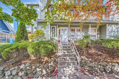 Welcome Home! Nestled gently just up from street level this unique duplex style single family townhouse features a South facing front door, western exposure, large private back yard, parking off street for 2 cars, one covered under a carport! | Image 1