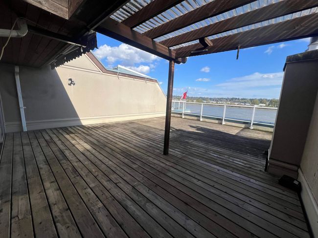 Wooden terrace with a pergola and a water view | Image 8