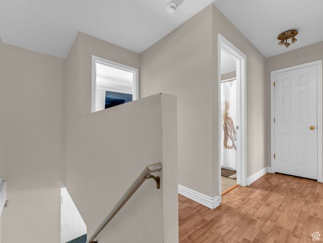 Corridor with an upstairs landing, light wood finished floors, and baseboards | Image 31