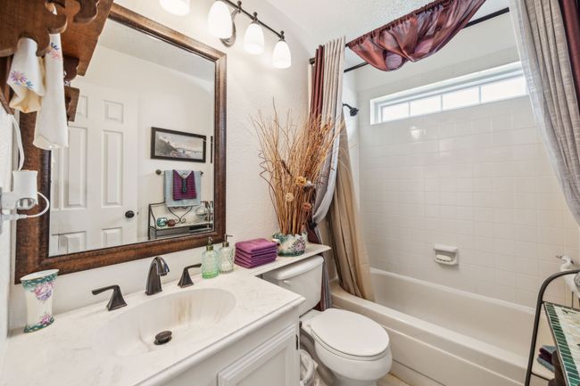 Full bath featuring vanity, shower / bathtub combination with curtain, and toilet | Image 5