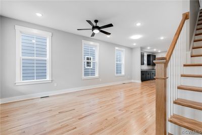 Unfurnished living room with light hardwood / wood-style floors and ceiling fan | Image 2