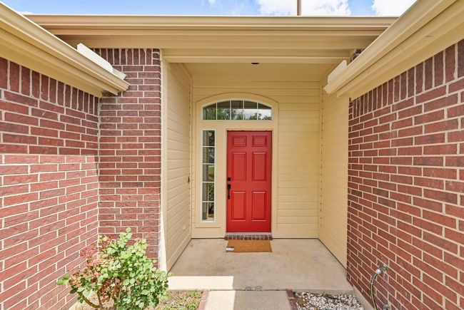 View of exterior entry featuring brick siding | Image 7