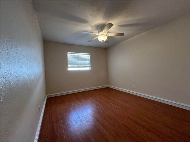 Empty room with baseboards, ceiling fan, and wood finished floors | Image 20