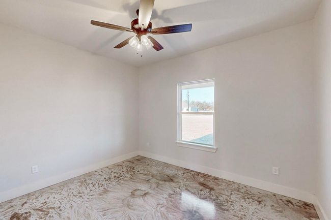 Unfurnished room featuring baseboards and ceiling fan | Image 29