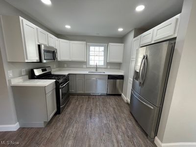 Kitchen with white cabinetry, quartz counters, appliances with stainless steel finishes | Image 2