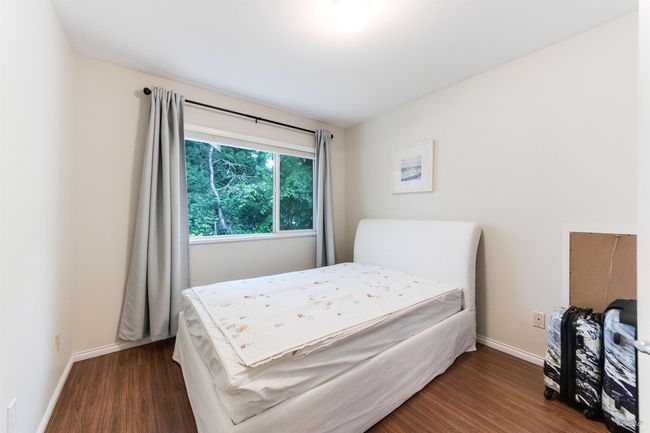 Bedroom with wood finished floors and baseboards | Image 11