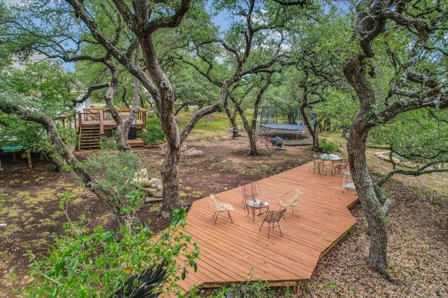 Located in a serene Hill Country setting, the home offers the perfect balance of peace and accessibility. | Image 34