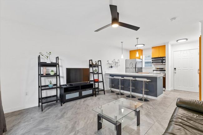 Living room with ceiling fan and baseboards | Image 8
