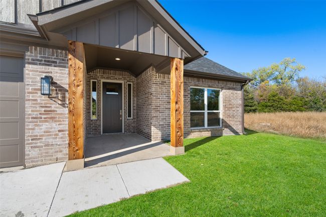Entrance to property with a lawn and a garage | Image 5