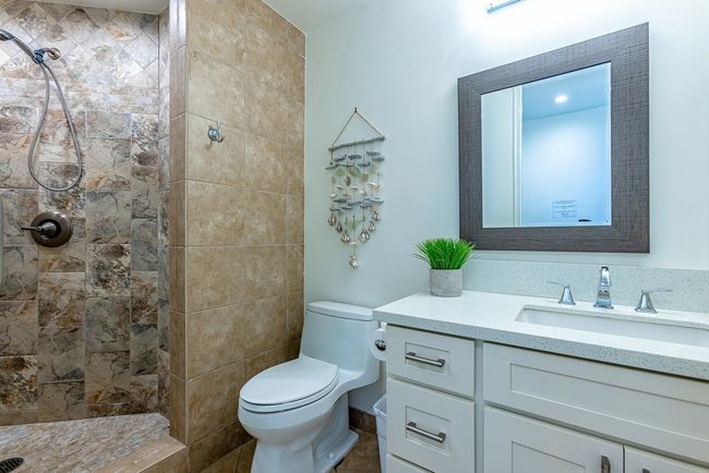 Bathroom 2 features a natural limestone countertop with a porcelain under-mount sink & a | Image 23
