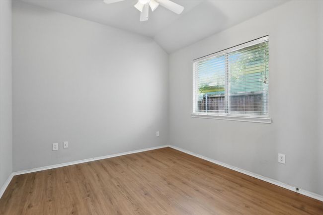 Spare room with wood finished floors, a ceiling fan, and lofted ceiling | Image 24