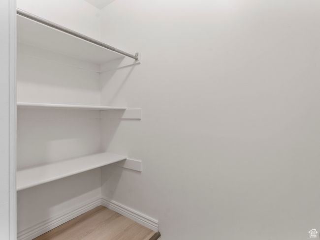 Spacious closet featuring light wood-type flooring | Image 21