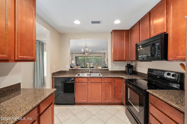 This large kitchen offers ample counter space and a cozy dine-in area for everyday living. | Image 4