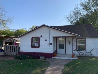 Bungalow-style house featuring a porch and a front lawn | Image 1