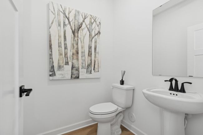 (Photo of a decorated model, actual homes finishes will vary) Convenient main level powder bath. | Image 8