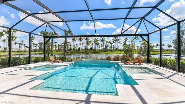 View of swimming pool featuring a water view, a patio, and glass enclosure | Image 15