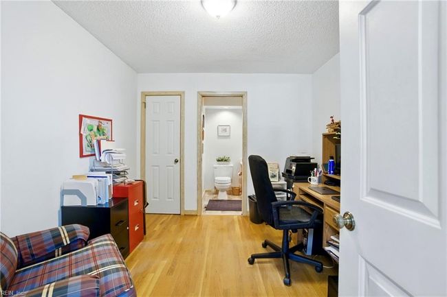Bedroom on the first floor with an attached half-bathroom. | Image 36
