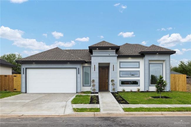 Prairie-style home with roof with shingles, an attached garage, stucco siding, and concrete driveway | Image 18