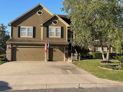 View of front of property featuring a garage and a front lawn | Image 1