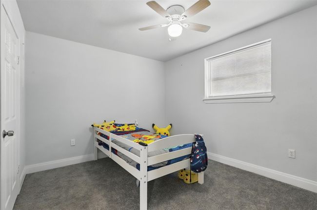 Carpeted bedroom with baseboards and a ceiling fan | Image 13