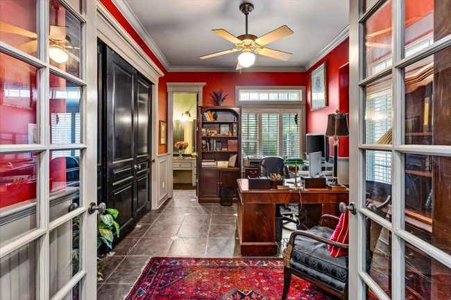 Spacious study has plenty of storage behind the solid built black doors, and looks onto the front garden. This room could also serve as a downstairs bedroom, as it has a full bath inside. | Image 21