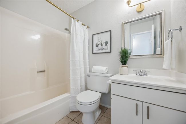 Bathroom featuring tile patterned floors, vanity, and shower / bath combo | Image 26
