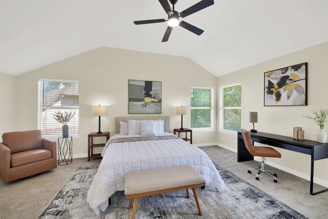 Bedroom with ceiling fan, carpet floors, vaulted ceiling, and baseboards | Image 11