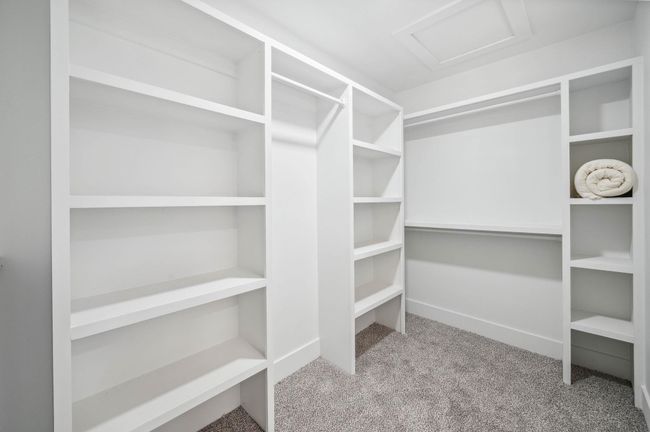 Walk in closet with carpet flooring and attic access | Image 18