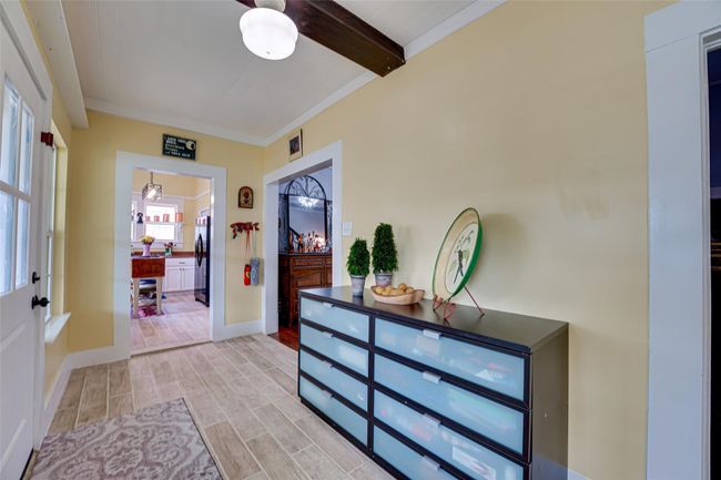 Entrance foyer featuring baseboards, beam ceiling, and light wood-style flooring | Image 11