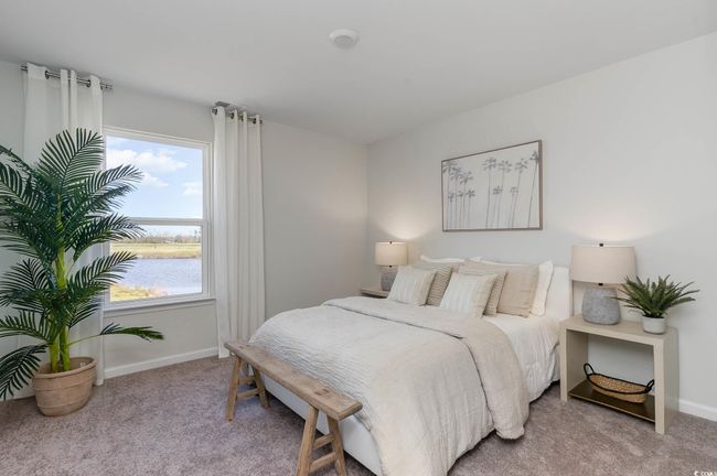 Carpeted bedroom featuring baseboards, multiple windows, and a water view | Image 19