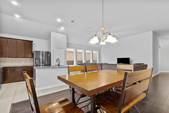 Dining space with a chandelier, recessed lighting, and wood-style flooring | Image 13