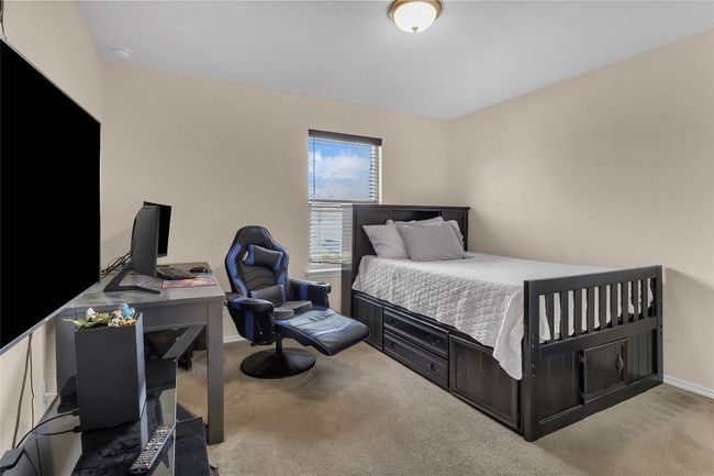 Carpeted bedroom with a desk and baseboards | Image 20