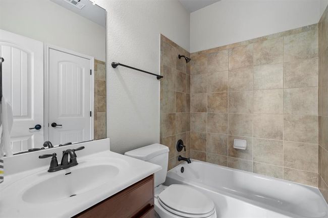 Full bathroom featuring vanity, toilet, and tub / shower combination | Image 27