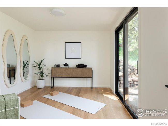 Accessed from the lower living space is the office/yoga room/art studio with an outdoor patio, baseboard heat | Image 30