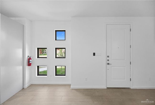 Empty room featuring plenty of natural light | Image 6