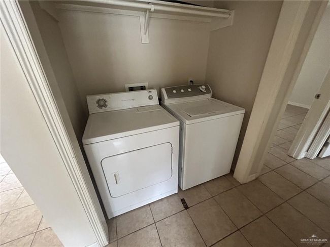 Washroom featuring washing machine and dryer and light tile patterned floors | Image 7