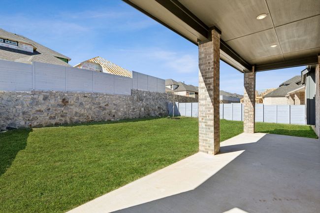 Fenced backyard with a patio area and a residential view | Image 6