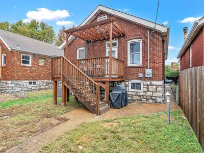 Rear view of property featuring a wooden deck and a yard | Image 2