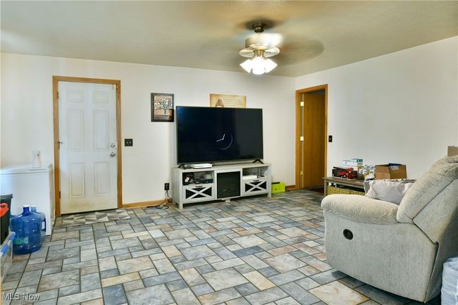 Living area with a ceiling fan and baseboards | Image 14