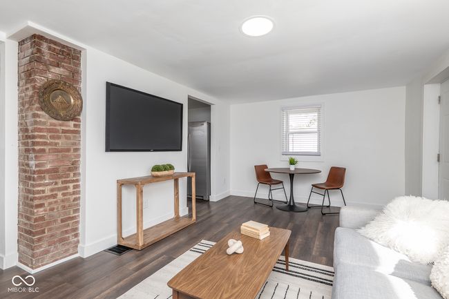 living area with baseboards and dark wood-type flooring | Image 4