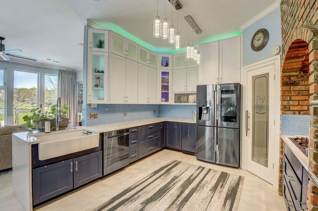 Custom cabinets, stainless steel appliances, farm sink, and a spacious walk-in pantry | Image 10