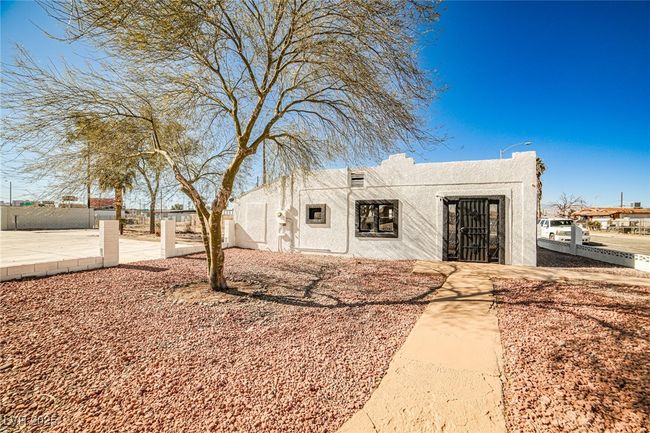 Pueblo-style house with stucco siding and a patio | Image 22
