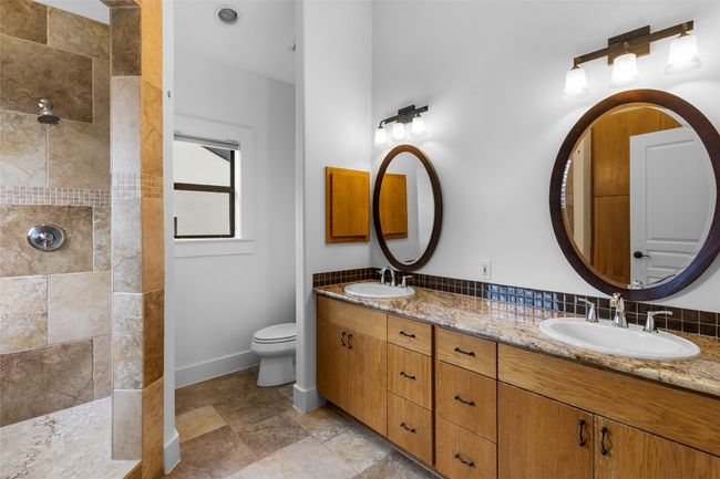 Full bath featuring double vanity, a walk in shower, and a sink | Image 20