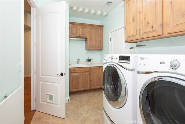 Spacious laundry room with sink and folding table | Image 45