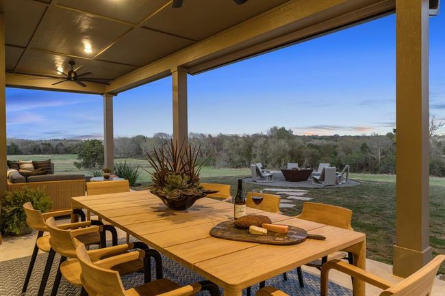 The staged dining space on the patio is the perfect place to unwind after a long day of shopping at the antique show. | Image 35