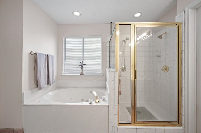 Primary bathroom offers jetted tub and separate shower too! | Image 32