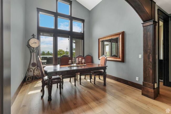 Formal dining space featuring arched walkways, high vaulted ceiling, light wood-type flooring, and baseboards | Image 9