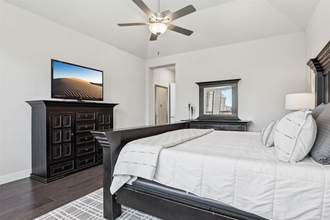 Bedroom with wood finished floors, lofted ceiling, and ceiling fan | Image 22